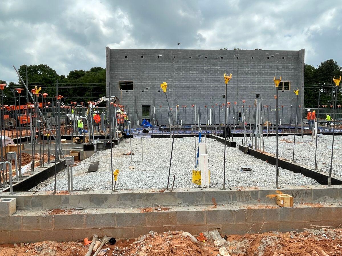 Fire station 9 Construction men standing around fresh cement