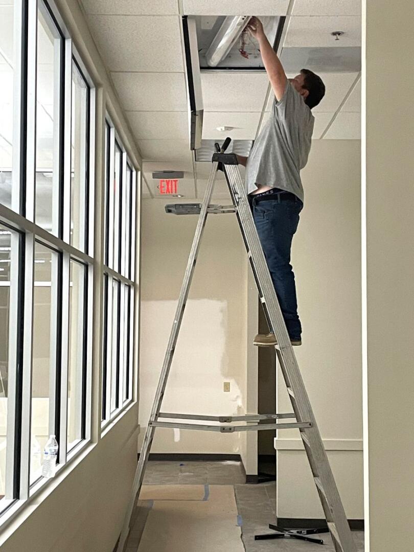 Small Business Incubator SPLOST update man fixing light fixture