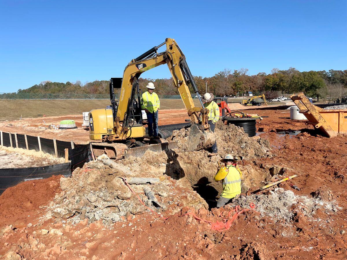 Lakeview Amphitheatre dirt with tracker on it with construction workers