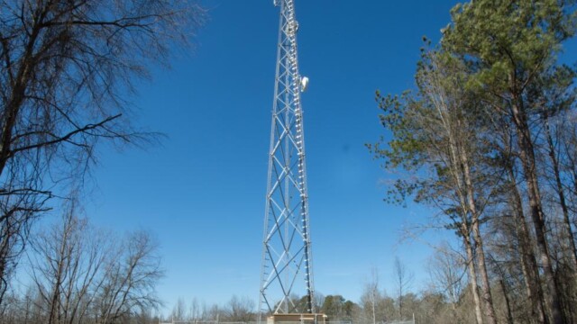 A radio tower surrounding by trees