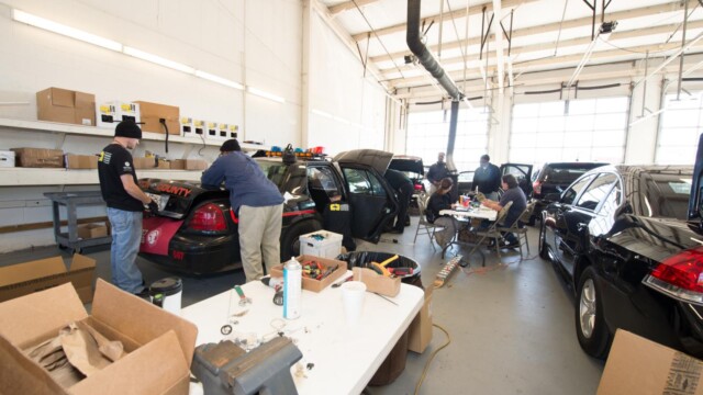 Police cruisers in garage for radio equipment being serviced