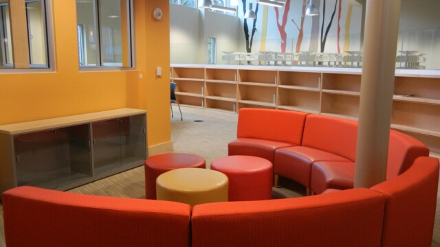 seating area with round orange sofa