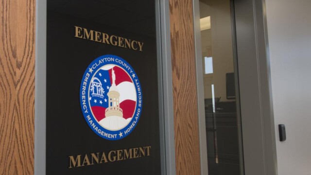Door with window displaying Clayton County Emergency Management logo and text