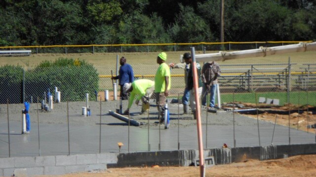 Workers smoothing concrete