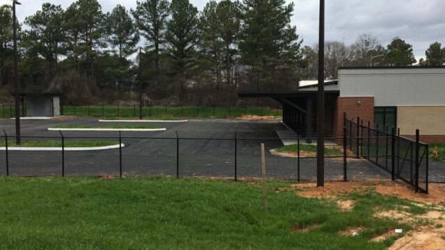 further back view of fenced in parking lot