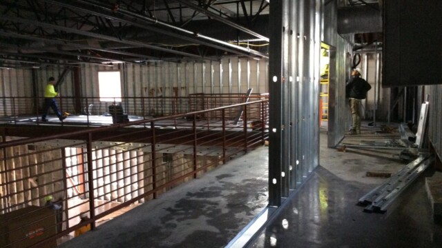 Construction workers framing using metal
