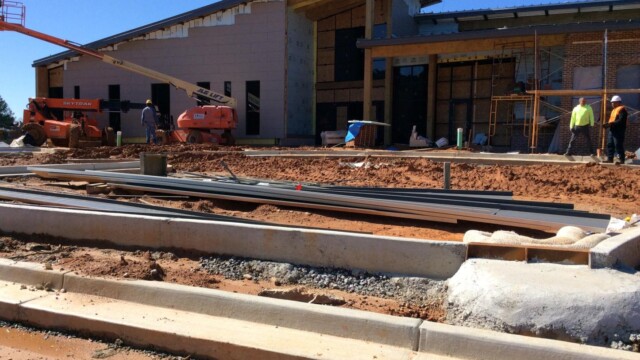 Construction workers and roofing material