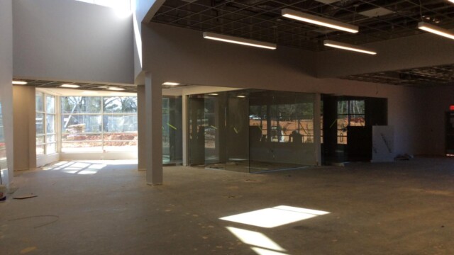 A glass corner and no ceiling tiles yet installed