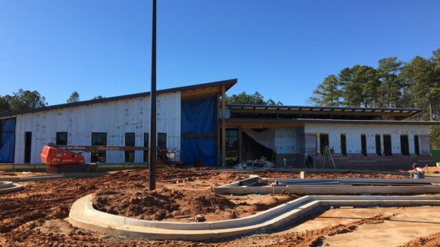 IT building walls with partial brick facade installed over a section of wall