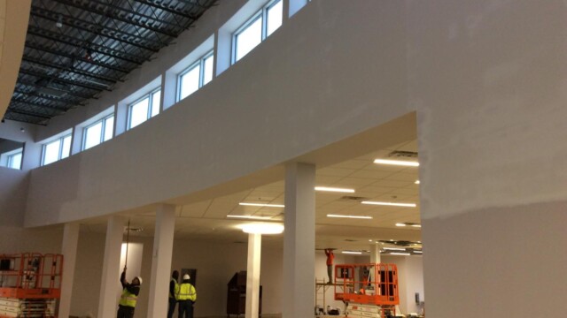 Construction workers filling in ceiling tiles 2
