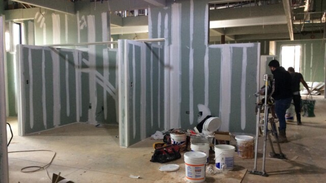 Contruction workers assembling inner walls