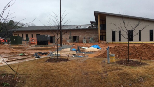 Trees planted around parking lot under construction at the IT Training center