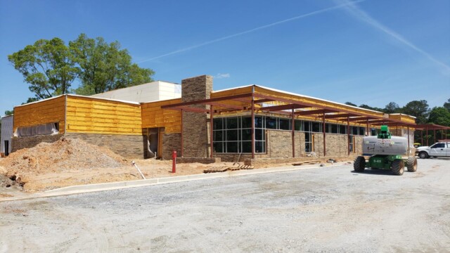 Exterior of building with walls being filled in with insulation