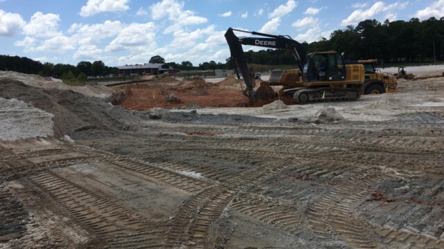 construction vehicles alongside dirt and cement