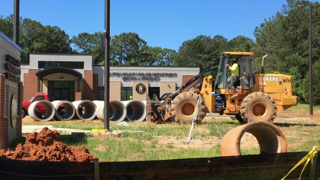 construction equipment and machinery in front of new building
