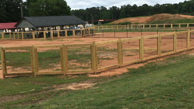 Bark Park fencing with pavilion in background