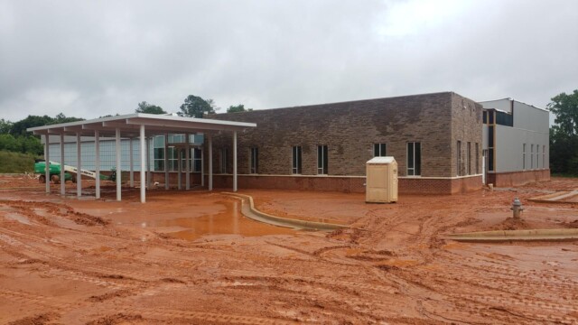 building under construction after a rain and muddy dirt all around