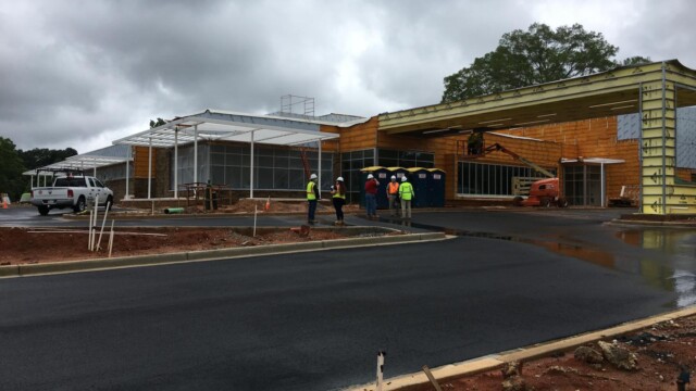 Construction workers plan their next move on a rainy day