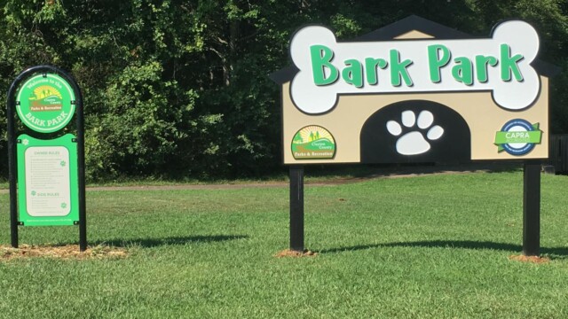 Bark Park sign next to sign of rules