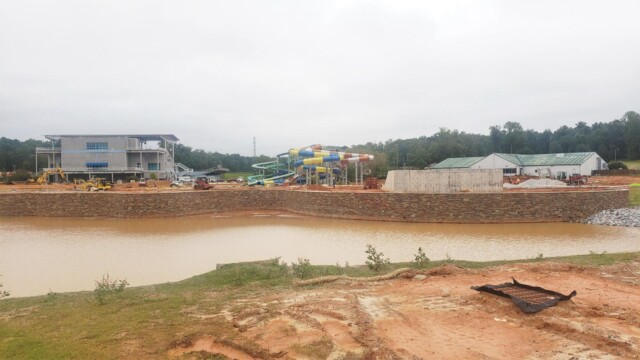 Muddy artificial lake surrounding the water park