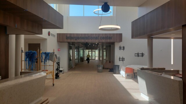 integenerational center signage in interior of with TV wall-mounts installed