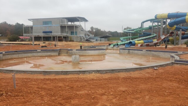 Empty pool with clay and rainwater