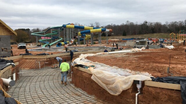 Workers install steel rebar before pouring concrete to form the pool bottom and sidewalls