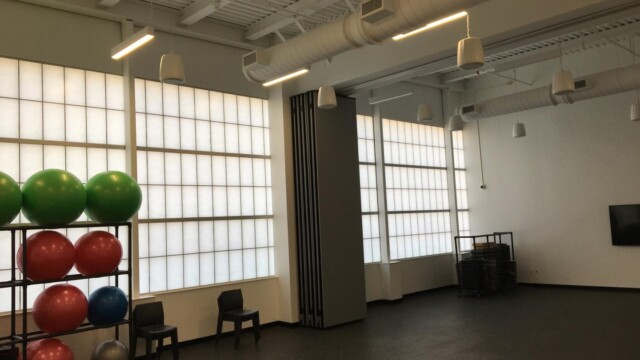 inside activity room with shelf of fitness balls
