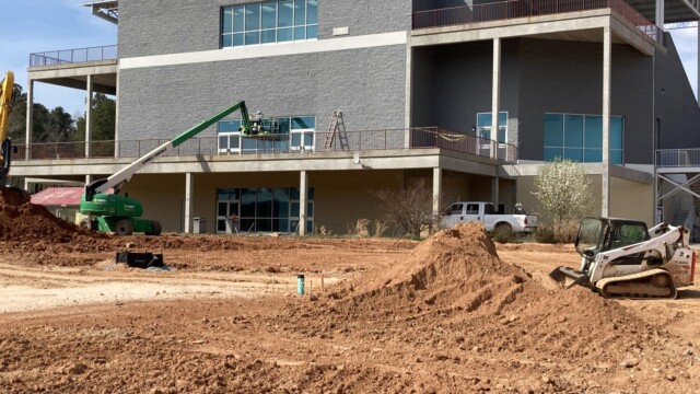 Boom lifted worker on second level balcony of VIP Complex