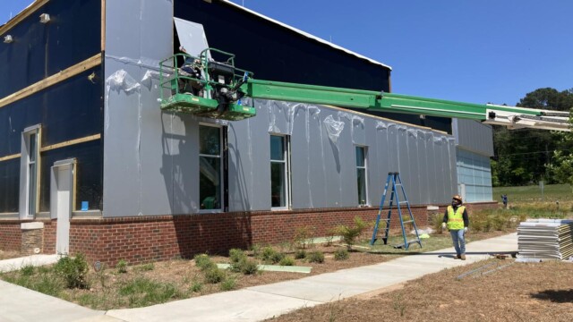 men on crane working on new building