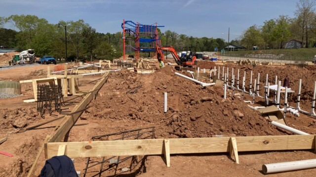 wood framing and PVC pipes in front of jungle gym