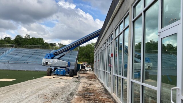 A boom lift accessing the second floor of the VIP Complex