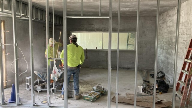 VIP Complex construction workers mixing up cement