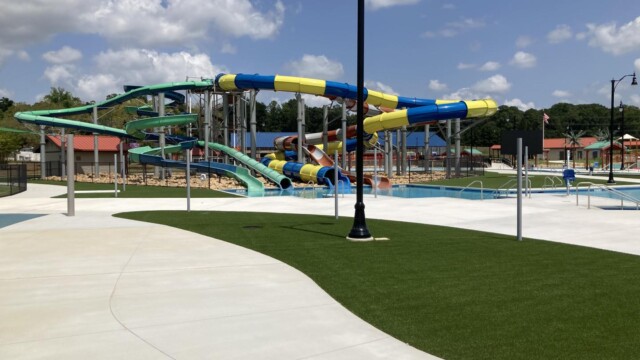 Grass and concrete surrounding the water slides of International Water Park