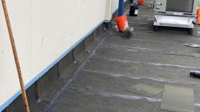 Jim Huie Roof with orange and black buckets