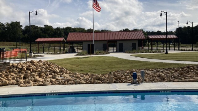 International Water Park entrance with American flag on pole, as seen from the pool