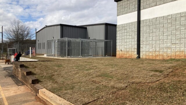 Clayton County Prison - Caged Entrance - Side View With Workers In The Background Clayton County Prison - Caged Entrance - Side View With Workers In The Background