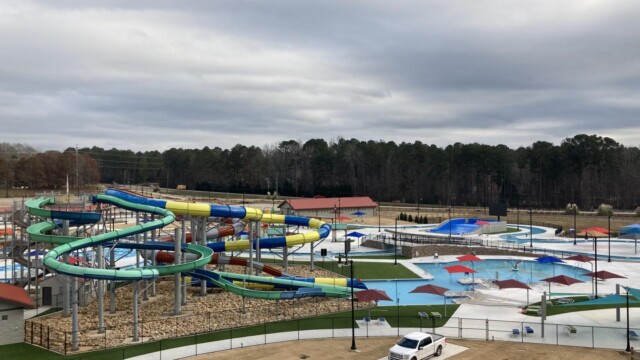 International Water Park with yellow and blue water slide and truck outside gate