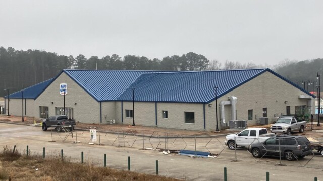 almost-completed Nassau Building with trucks parked on the sides