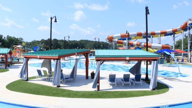 lounge seats under pergolas near Splash Pad area