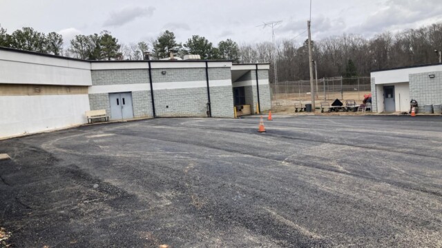 Clayton County Prison - Parking Lot With Gravel Road Side Entrance Clayton County Prison - Parking Lot With Gravel Road Side Entrance