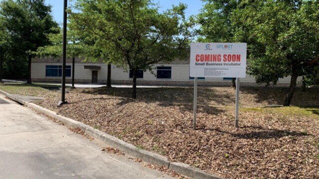 outside the building before renovations with Coming Soon sign
