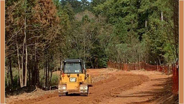 cleared land with truck driving
