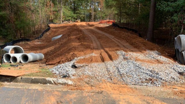 cleared land for path with concrete tubes