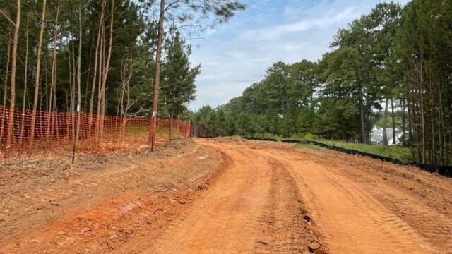 wide path of orange dirt as land was cleared