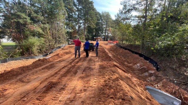 3 people on freshly ground land