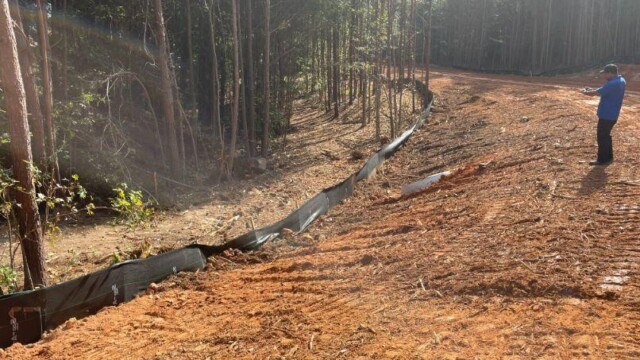 wide view of man taking picture of freshly dug up land