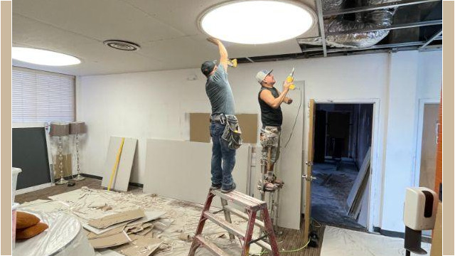 Workers fill the ceiling with tiles