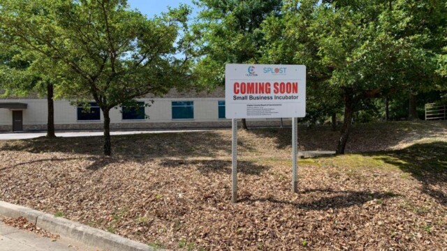 Coming Soon sign in front of old building