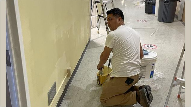 Worker paining walls